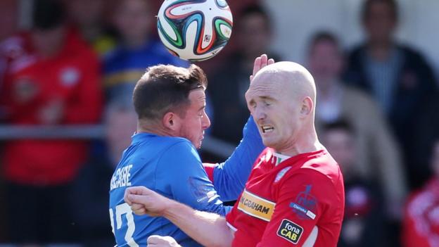 Midfielders Shane McCabe and Ryan Catney challenge for the ball during the 3-3 draw at Solitude