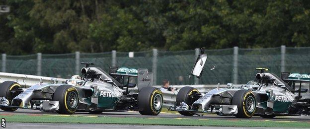 Lewis Hamilton is hit by Nico Rosberg, right