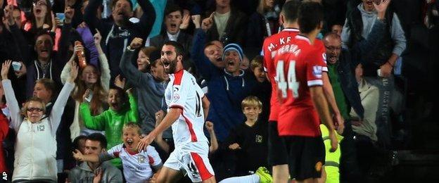 Will Grigg celebrates MK Dons second goal against Manchester United