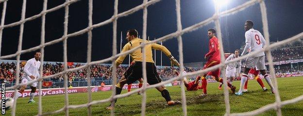 Wayne Rooney scores against Montenegro in a World Cup qualifier in 2013