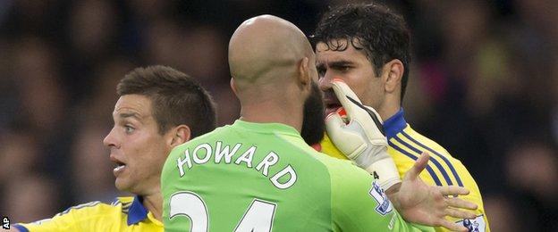 Diego Costa is confronted by Everton keeper Tim Howard