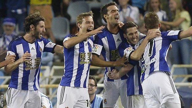 The Real Sociedad players celebrate a David Zurutuza goal