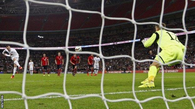 Wayne Rooney scores from the penalty spot for England