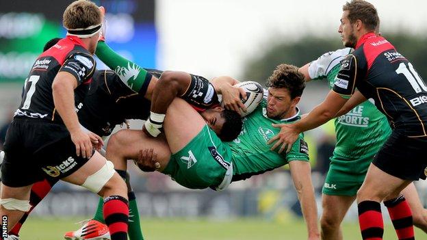 Aled Brew of the Draons tackles Connacht's Danie Poolman