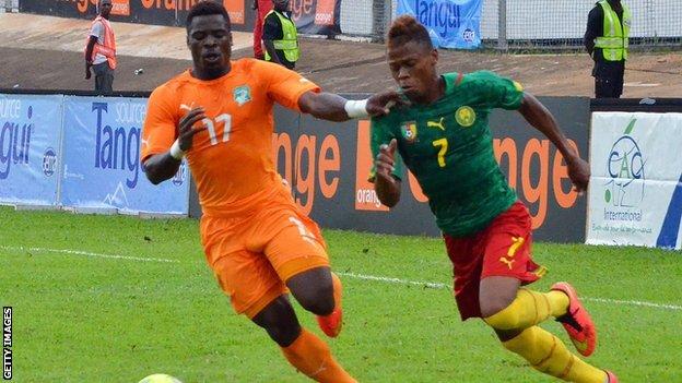 Ivory Coast's Serge Aurier and Cameroon's Clinton Njie vie for the ball