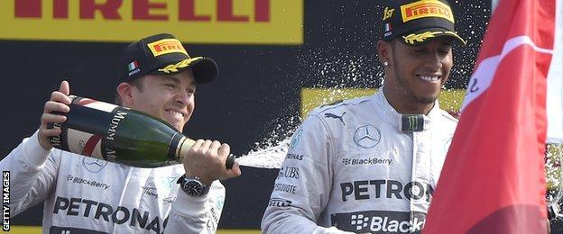 Nico Rosberg sprays Lewis Hamilton with champagne on the podium at Monza