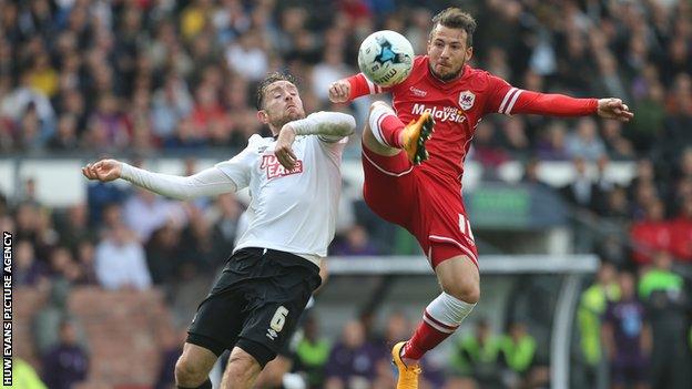 Cardiff City's Adam Le Fondre is challenged by Derby County's Richard Keogh