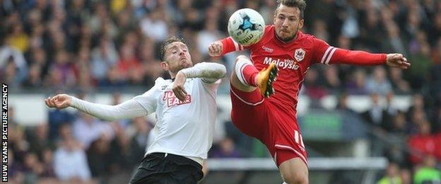 Cardiff City's Adam Le Fondre gets a shot at goal as Derby County's Richard Keogh challenges