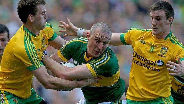 Kieran Donaghy of Kerry in possession against Donegal's Neil McGee and Leo McLoone