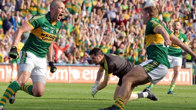 A delighted Kieran Donaghy celebrates as Donegal keeper Paul Durcan rues his mistake which led to the forward's second-half goal