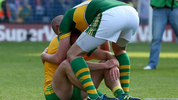 A dejected Michael Murphy is consoled by Kerry goalscorer Kieran Donaghy at the final whistle