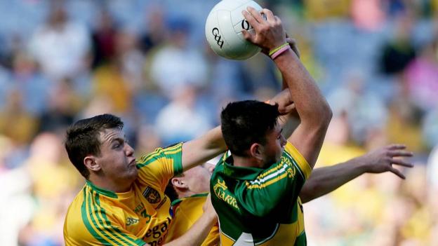 Donegal's Ciaran Gillespie makes the challenge as Liam Kearney catches the ball for Kerry