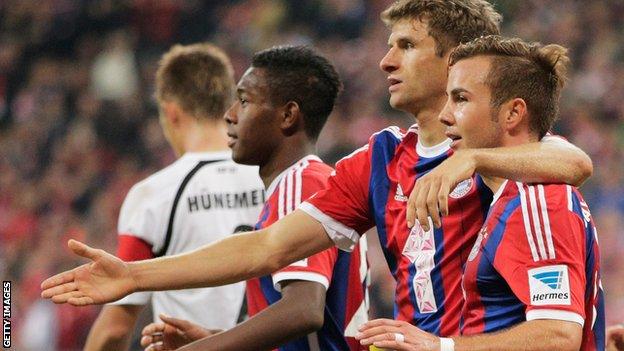 Mario Gotze (right) is congratulated by Thomas Muller (centre)