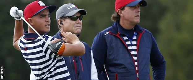 U.S. Ryder Cup player Phil Mickelson and captain Tom Watson watch Rickie Fowler tee off during practice ahead of the 2014 Ryder Cup at Gleneagles