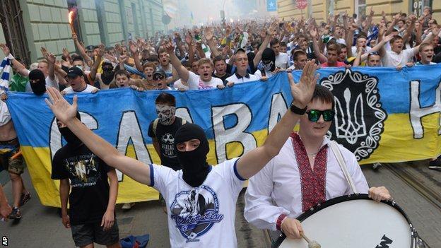 Ukrainian fans of FC Dynamo Kiev, FC Karpaty Lviv and FC Shakhtar Donetsk shout slogans during the 'March of Unity' in the western Ukrainian city of Lviv on July 22, 2014.