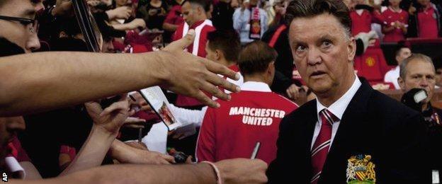 Louis van Gaal is mobbed by supporters on Manchester United's pre-season tour