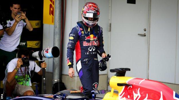German Formula One driver Sebastian Vettel of Red Bull Racing looks at his car at the end of qualifying at the Suzuka Circuit in Suzuka