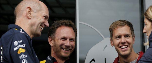 Infiniti Red Bull Racing Team Principal Christian Horner smiles as he speaks with Adrian Newey, the Infiniti Red Bull Racing Chief Technical Officer and Sebastian Vettel.