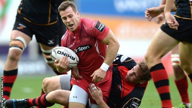 Gareth Davies is tackled by T Rhys Thomas