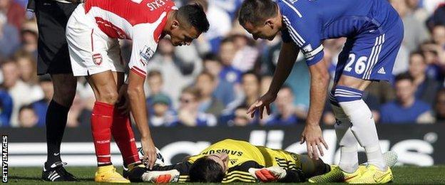 Chelsea's Thibaut Courtois left the pitch with a head injury after a collision with Alexis Sanchez