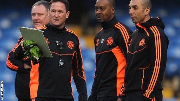 Roberto Di Matteo (right), interim first team coach talks with his assistants Eddie Newton (second right) and Steve Holland (second left)