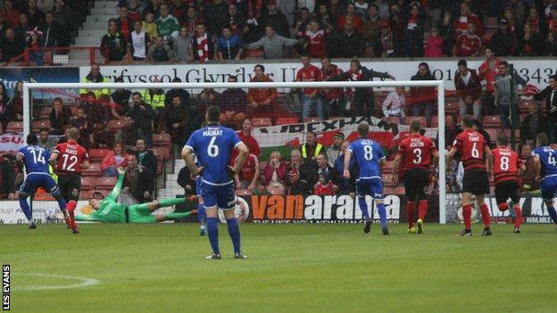 Lenell John-Lewis holds his nerve from the penalty spot to spoil Wrexham's 150th birthday celebrations