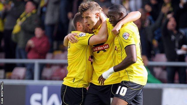 Jacob Blyth (centre) is congratulated after opening the scoring for Burton at Northampton