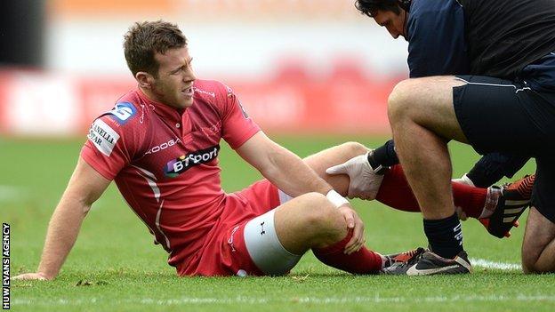 Gareth Davies receives treatment before leaving the field