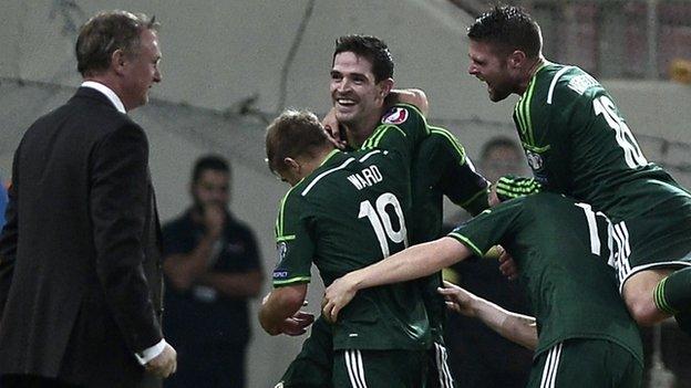 Kyle Lafferty is embraced after scoring Northern Ireland's second goal against Greece