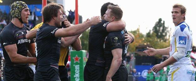 Chris Ashton is mobbed by his team-mate after scoring his second try against Clermont