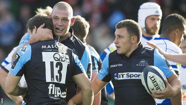The Glasgow Warriors players celebrate after Mark Bennett scores against Bath