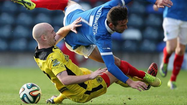 Cliftonville's Ryan Catney and Linfield striker Andrew Waterworth hit the deck during the Belfast derby at Windsor Park