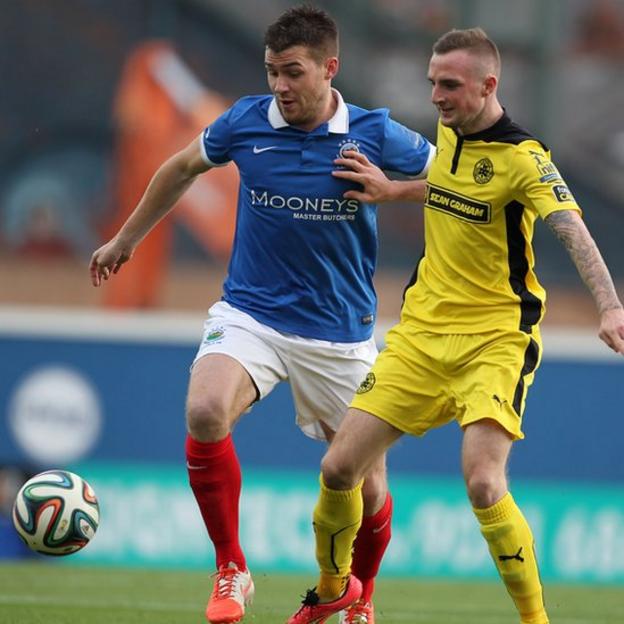 Stephen Lowry of Linfield in action against Cliftonville's Jude Winchester