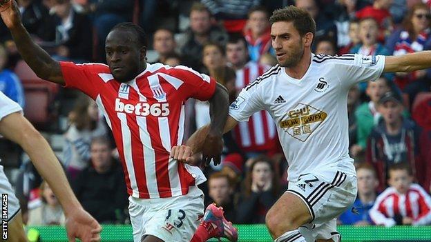 Stoke winger Victor Moses (left) went down following a challenge by Swansea defender Angel Rangel