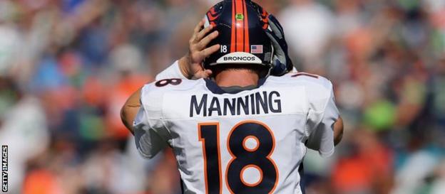 Peyton Manning uses a headset to communicate with the coaching team on the sidelines