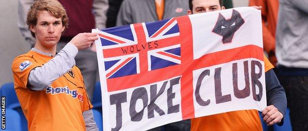 Wolves supporters hold up a "joke club" banner