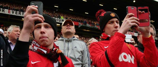Manchester United fans film action on their camera phones