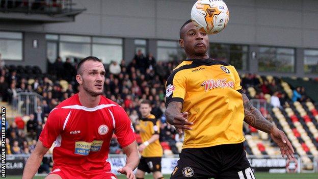 Newport County's Aaron O'Connor is closely eatched by Tom Aldred