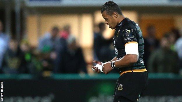 Luther Burrell holds his injured hand