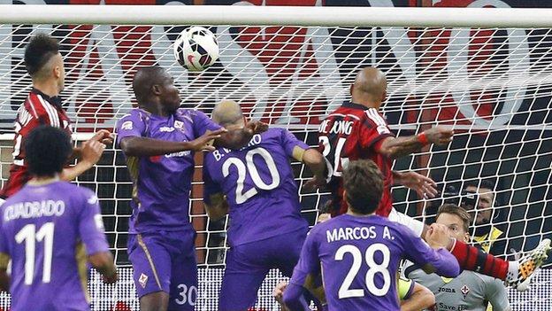 AC Milan midfielder Nigel de Jong heads his side into the lead against Fiorentina