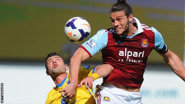 Andy Carroll wins a towering header to West Ham