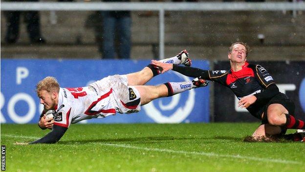 Stuart Olding gets ahead of Angus O'Brien to go over for his first try against the Dragons