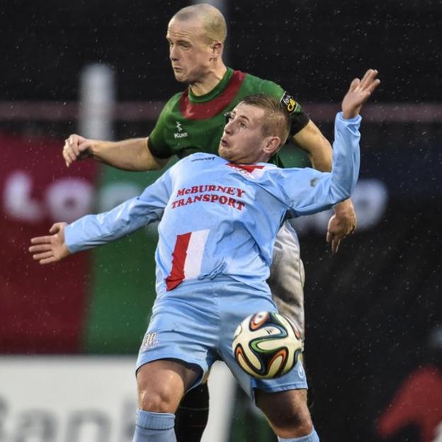 Glentoran defender Barry Holland competes with David Cushley of Ballymena United at the Oval