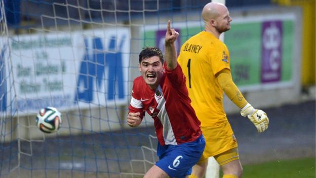 Jimmy Callacher turns away to celebrate after heading Linfield's winner in the 2-1 victory away to Glenavon