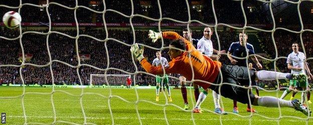 Shaun Maloney's shot evades the reach of Irish goalkeeper David Forde