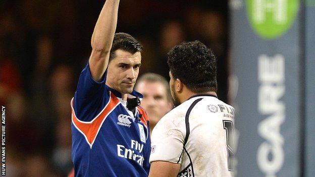 Referee Pascal Gauzere shows Campese Ma'afu a red card