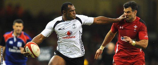 Fiji's Vereniki Goneva hands off Wales' Mike Phillips