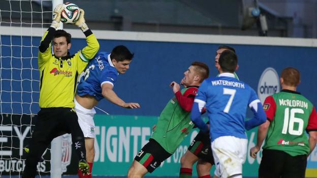 Glentoran keeper Elliott Morris catches the high ball to deny Linfield's Jimmy Callacher in the 'Big Two' clash at Windsor Park