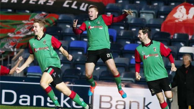 Johnny Addis runs away in delight after his late equaliser gives Glentoran a 2-2 draw against the Blues
