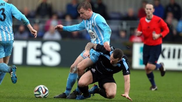 Warrenpoint Town's Liam Bagnall is tackled by Ballymena United opponent Neal Gawley at Milltown